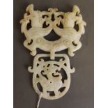 A Chinese white jade pendant in the form of two entwined dragons, 5'' long