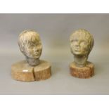 A pair of composite stone casts, busts of a boy and girl, on wood mounts, 15'' high