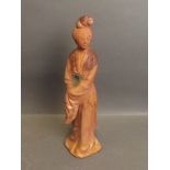 A Chinese terracotta figure of women, traces of brown and green glaze, 9½'' high