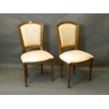 A pair of Continental side chairs with shaped backs and seats, on turned and fluted supports