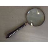 A large magnifying glass with an ebonised turned wood handle, 14½'' long