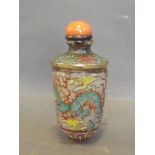 A Peking glass snuff bottle painted with coloured enamels depicting a dragon chasing the flaming