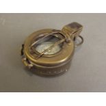 A military style brass compass, marked 'T.G. & Co., London', 2½'' diameter