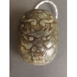 A Chinese jade buckle with carved dragon mask decoration, 2'' long