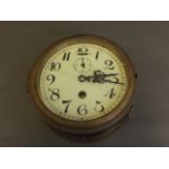 A brass cased ship's bulkhead clock, 7½'' diameter (glass AF)