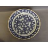 A large Chinese blue and white dish decorated with three horses and prunus flowers, 11½'' diameter