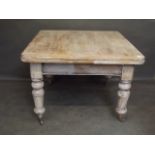 A Victorian pine draw leaf dining table on turned supports and brass castors, 42'' x 30'' x 42'',