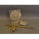 An extended brass toasting fork, a brass figure of a frog, a calendar, and a 'British by Birth'