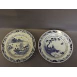 Two blue and white Chinese plates decorated with a fisherman and fishing scene to centre, and