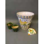 A large Faience terracotta jardinière, and three pottery wall pockets, 15'' x 17''