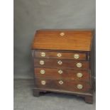 A George III mahogany fall front bureau with fitted interior over four long drawers, on bracket