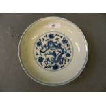 A Chinese blue and white dish decorated with a dragons, 6 character mark to base, 7½'' diameter