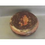 An Oriental circular lacquer box with gilt decoration of flowers and figures, containing a