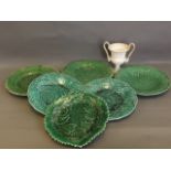 Six English green ground pottery leaf plates, and a Wedgwood twin handled urn, 9'' diameter