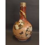 A Japanese Meiji period vase painted with lilies and raised dragon decoration, with gilt highlights,