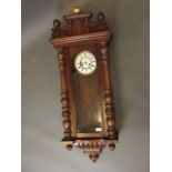 A C19th Vienna walnut wall clock with turned and moulded case and enamel dial, 46'' high (AF