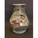 A Chinese green enamelled vase with a basket weave decoration and painted dragon and carp, with lion