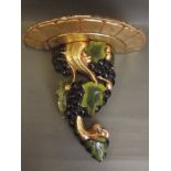 A gilt and painted wood wall bracket in the form of a fruiting vine, 14'' high