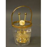 A crystal glass ice bucket with gilt metal mounts, tongs and strainer, retailed by Aspreys, 5'' high