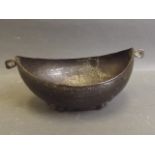 A C19th Indo-Persian navette shaped hammered copper bowl with raised engraved decoration, 7'' long