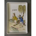 A Chinese porcelain tray with enamel decoration depicting a fisherman and his companion, with