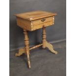 A C19th Continental pine work table with two drawers, on end column supports and shaped legs, 18'' x