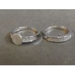 A silver and cubic zirconia dress ring, size T, and matching half eternity ring