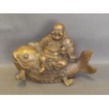 A Chinese bronze figure of Buddha seated upon carp, 11'' wide