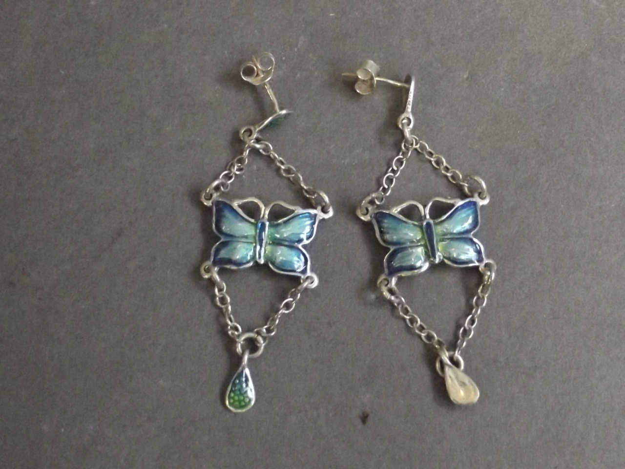 A pair of silver and enamel earrings in the form of butterflies