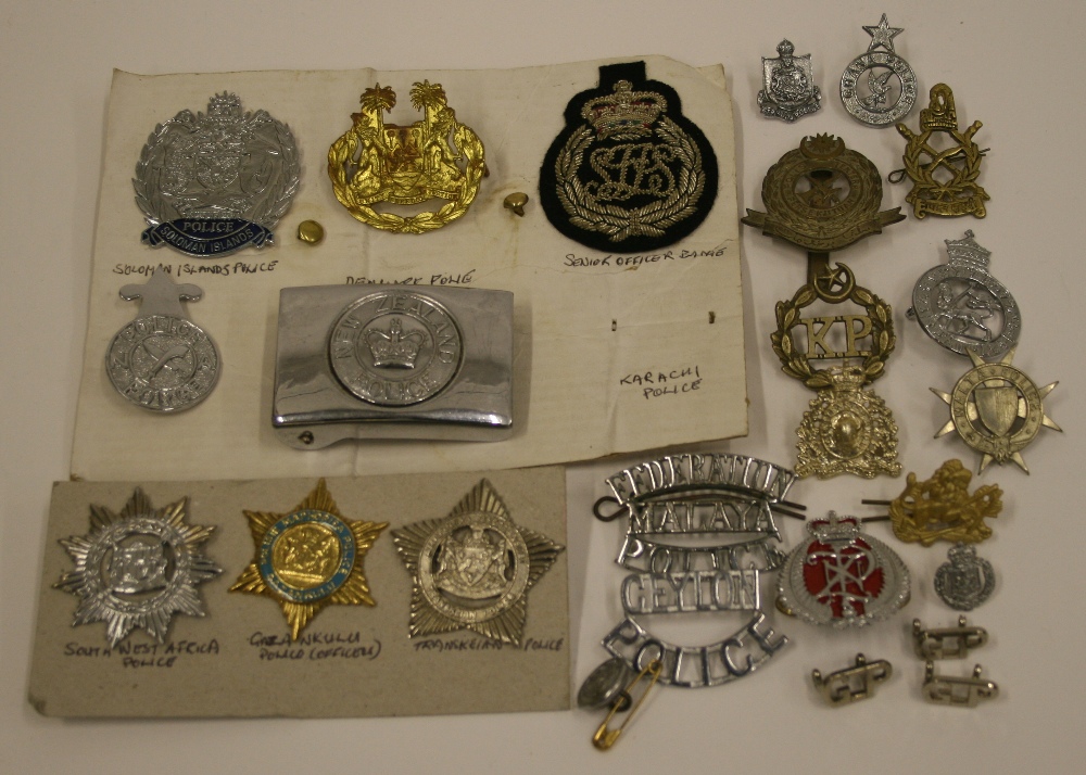 Selection of International Police Badges consisting of New Zealand Police belt buckle, Ceylon Police