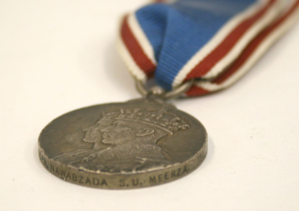 George VI 1937 Coronation Medal named around the rim to “INSPR NAWABZADA S.U.MEERZA.” Medal has some