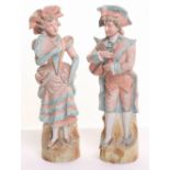Continental Porcelain Figures of a Gentleman & Lady in dress of the 18th / 19th century. Figures are