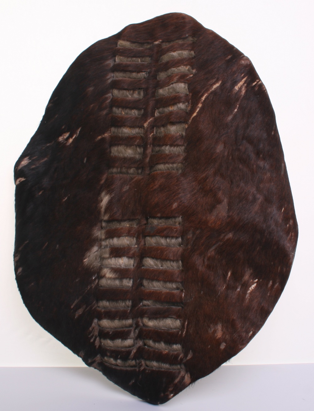 19th Century Zulu Dance Shield, of animal hide with much of the brown and white fur to the front.