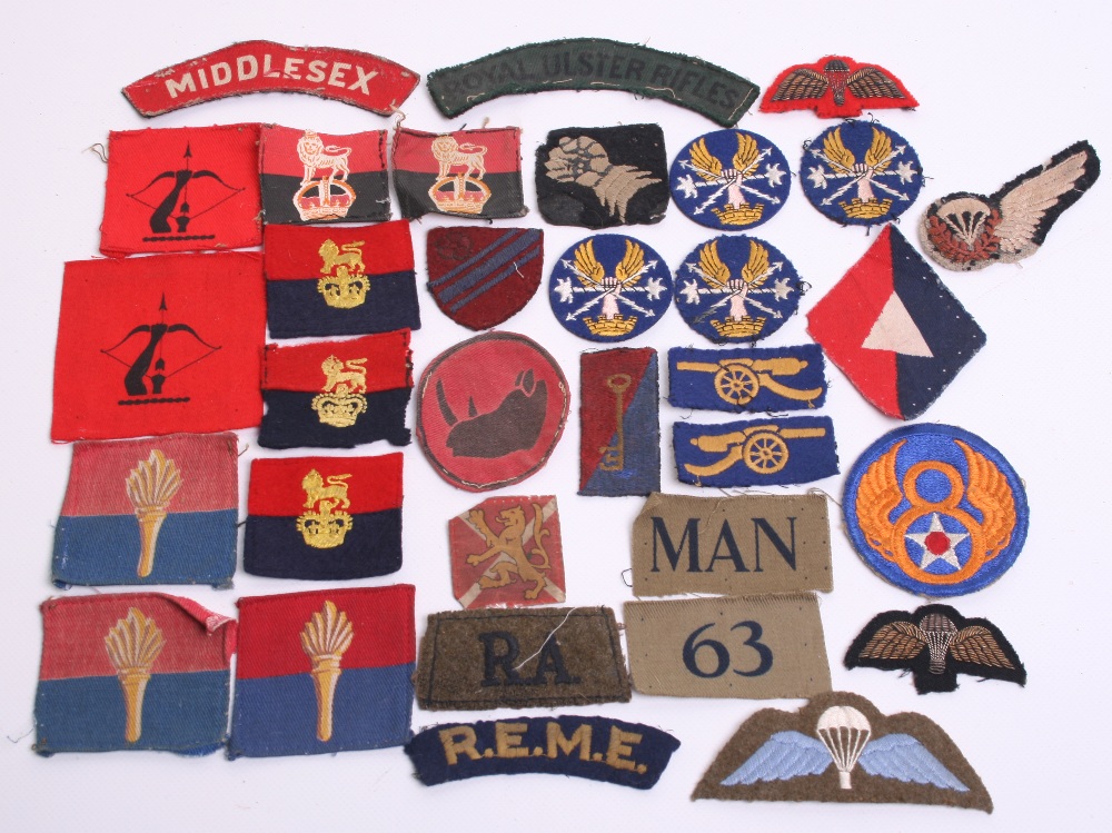 Selection of British Cloth Insignia including printed ROYAL ULSTER RIFLES cloth shoulder title,