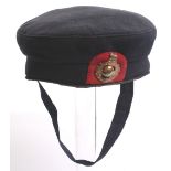 Female Royal Marines Cap of blue wool with red patch to the front having polished brass Royal