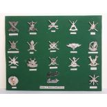Selection of Sultan of Omans Land Forces Badges all mounted onto a display board with details of the