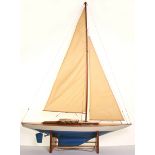 A motorised wooden model Pond Yacht, with painted blue and cream hull, wooden teak effect deck and