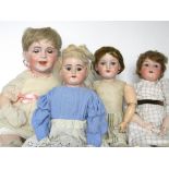 Three German bisque head girl dolls, including an A.M 390 with weighted blue glass eyes, upper