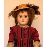 Mon Cherie bisque head doll, French circa 1910, with weighted blue glass eyes, open mouth and