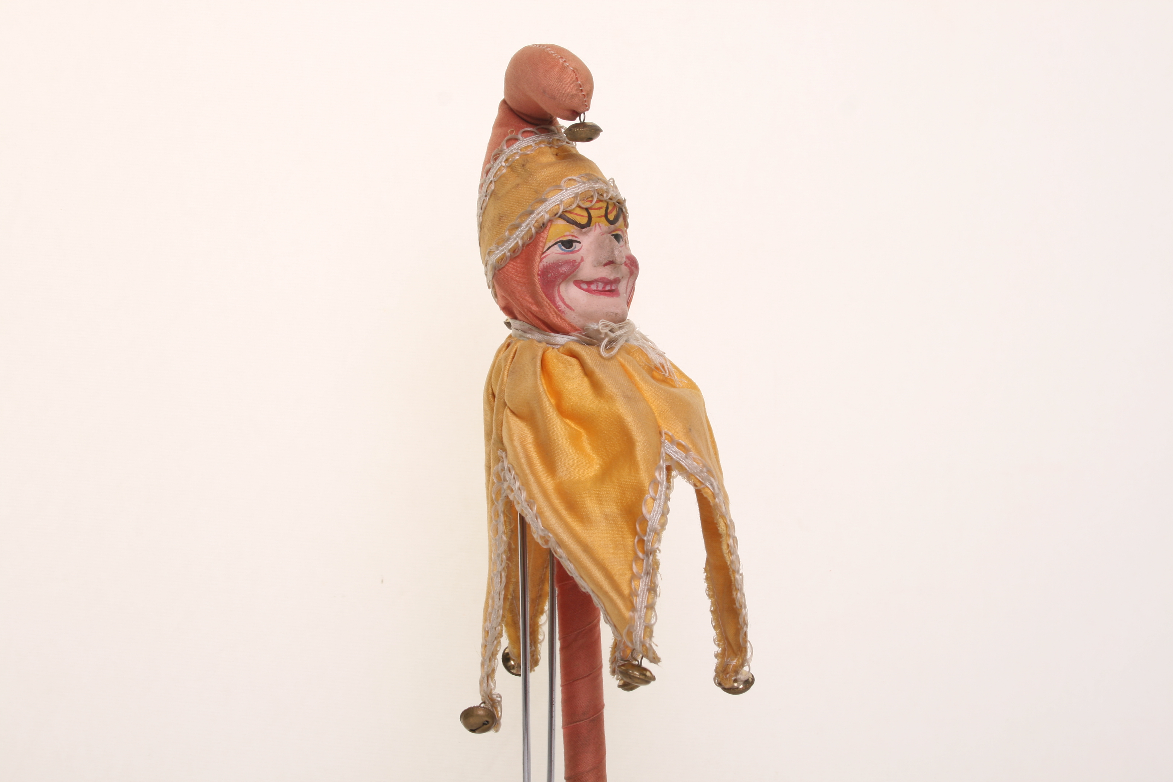 Papier-mache Punch on stick, circa 1900, with exaggerated painted features, original yellow and