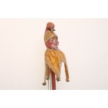 Papier-mache Punch on stick, circa 1900, with exaggerated painted features, original yellow and