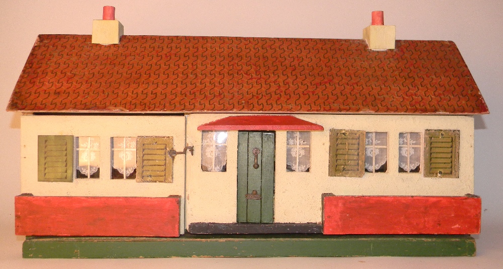 Painted wooden cottage, circa 1930, with cream exterior, six windows with four card printed