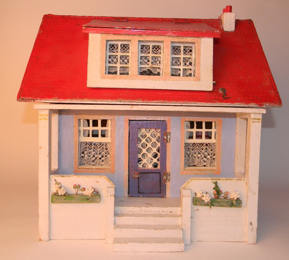 Painted wooden dolls house with veranda, circa 1910, with white and blue exterior and steps