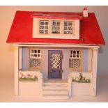 Painted wooden dolls house with veranda, circa 1910, with white and blue exterior and steps