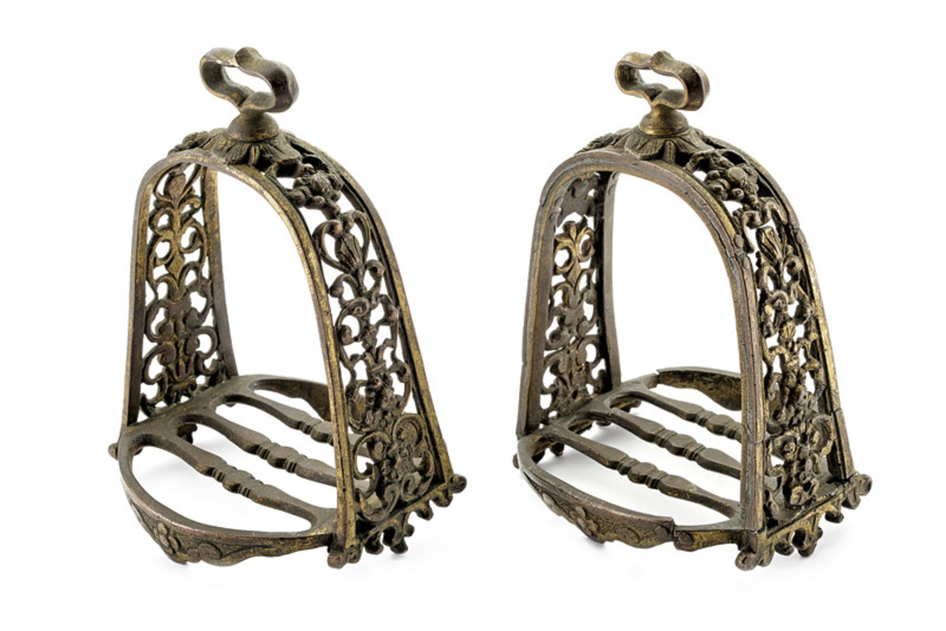 A rare pair of pierced bronze stirrups dating: 18th Century provenance: France Featuring remains