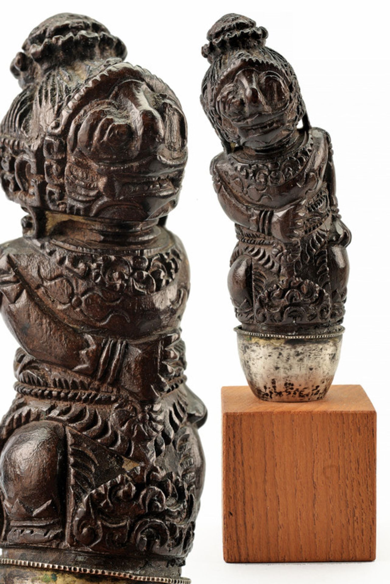 A kris hilt dating: late 19th Century provenance: Indonesia Wooden hilt carved as a deity; with