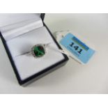 Dress ring set with a green stone stampe