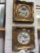 Pair of circular cast plaques in gilt fr