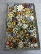 Costume brooches and rings in one box