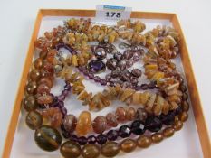 Three amber necklaces and two other necklaces